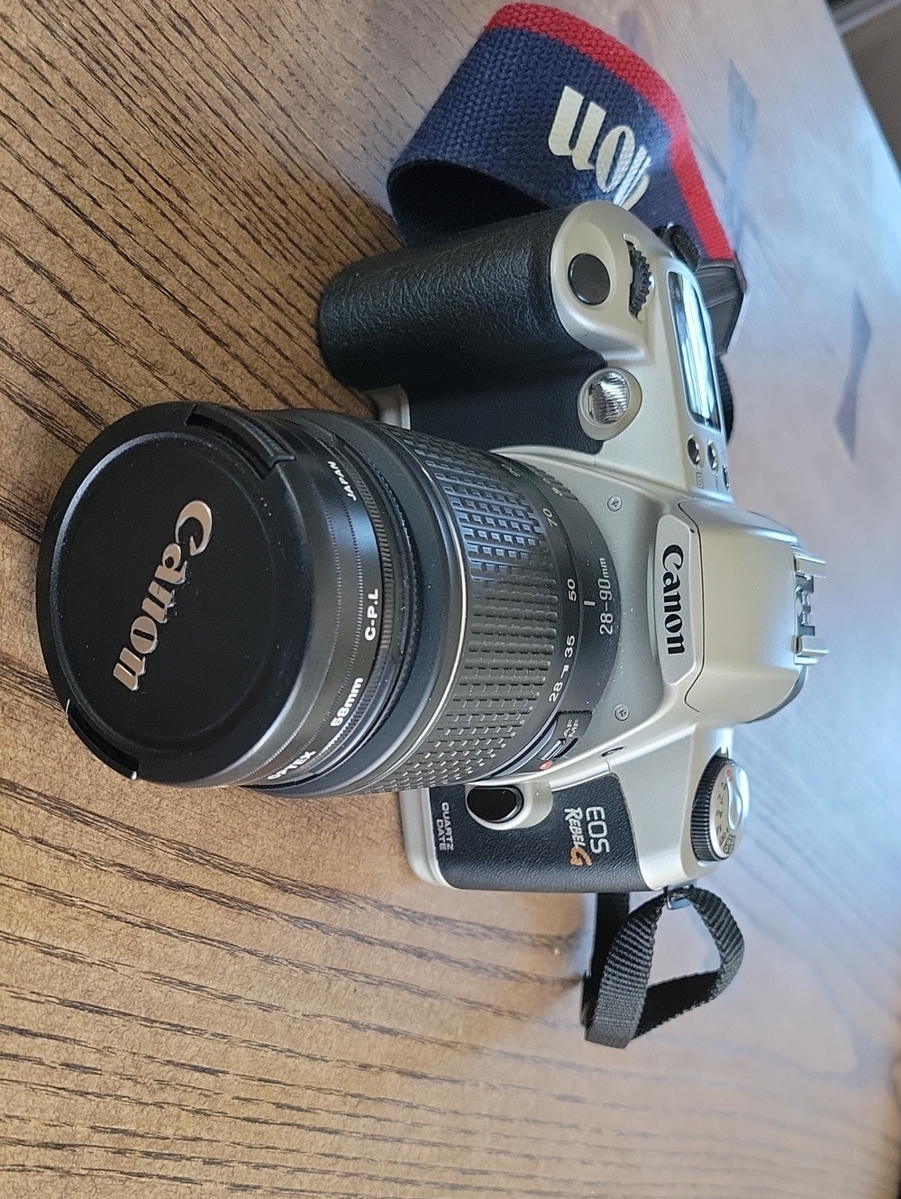 Canon silver and black 35mm with Canon-branded lens, Polarizing Plus UV Filters